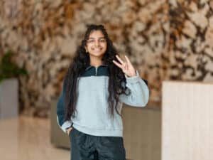 Student holding up ASU hand signal