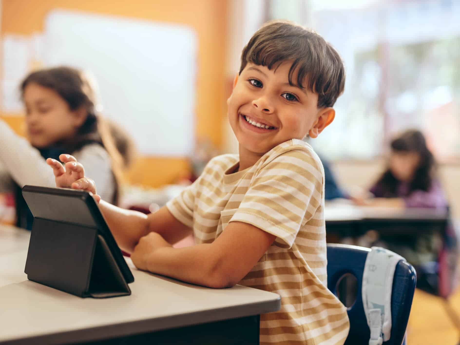 Students in a classroom with ipads